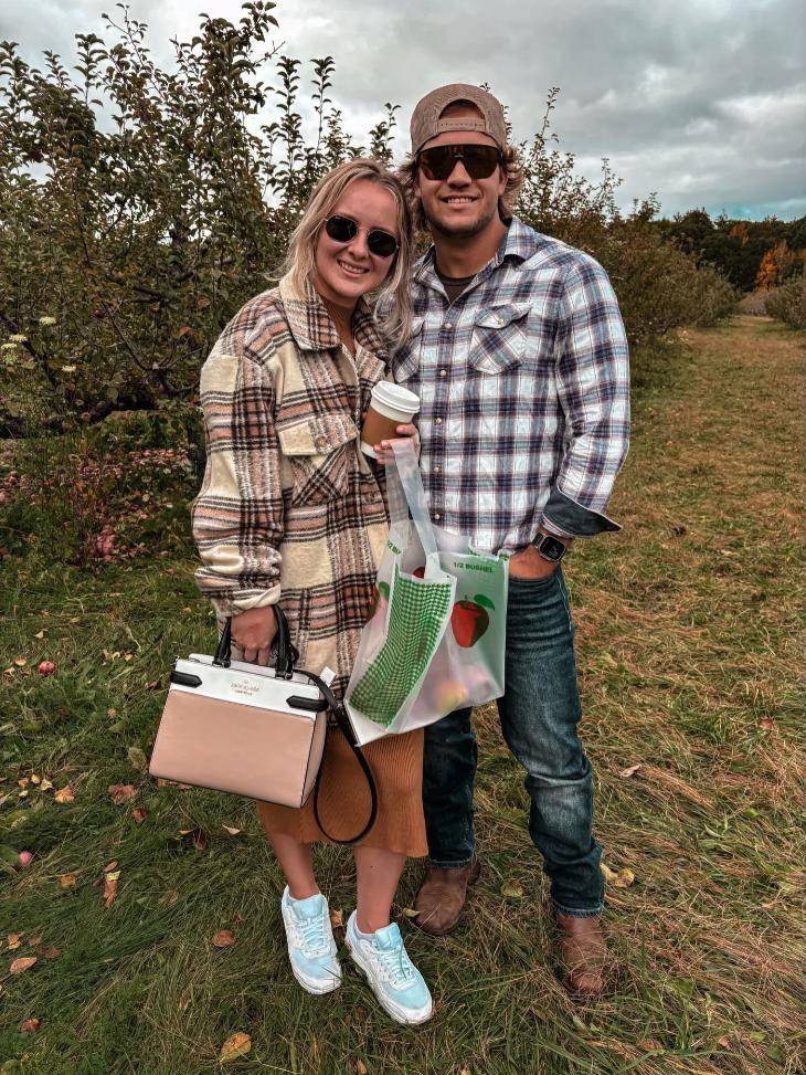 Nate and his wife at an apple orchard in the fall